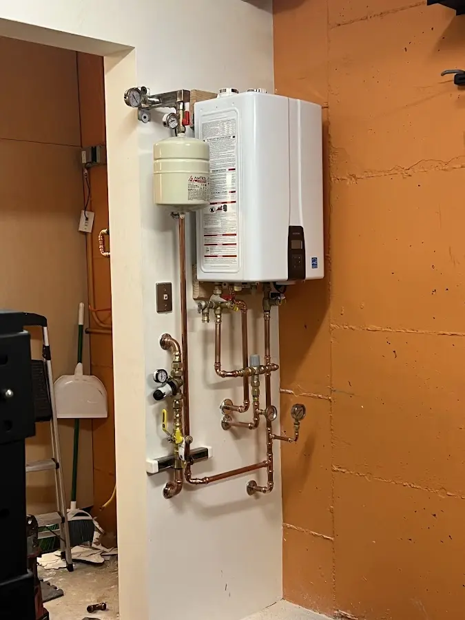 Plumbing technician inspecting water heater connections in Monte Sereno